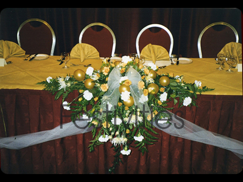 Gold top table with balloons and flowers