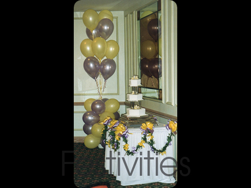 Cake table decorated with lilac and yellow balloons